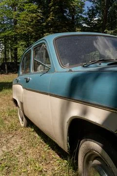Angled Side View of Two Tone Vintage Soviet Sedan Parked in Green Park Stock Photos