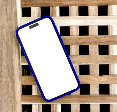 Angled smartphone mockup with blank screen on wooden lattice. Blue mobile pho Stockfoto's