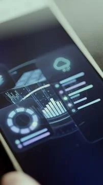 Angled smartphone screen displays a cloud indicator, rising performance Stock Photos