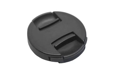 An angled studio shot of the front of a black camera lens cap featuring rai.. Stock-Fotos