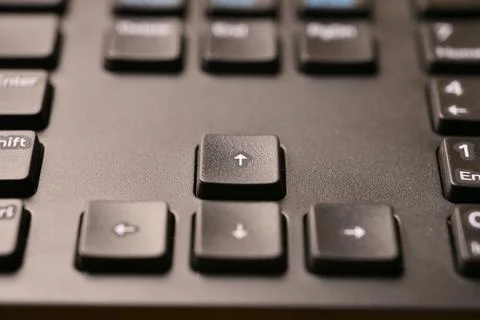 Angled Top View Macro Close-Up Black Keyboard Highlighting Up Arrow Key wit.. Stock Photos