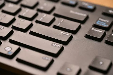Angled Top View Macro Close-Up Black Computer Keyboard Highlighting Enter K.. Stock Photos