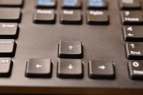 Angled Top View Macro Close-Up Black Computer Keyboard Highlighting Up Arro.. Stock Photos
