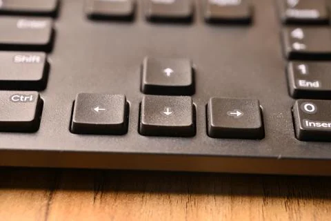 Angled Top View Macro Close-Up Black Computer Keyboard Highlighting Down Ar.. Stock Photos