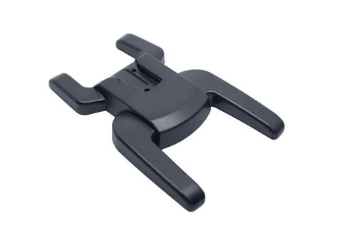 An angled view of a black plastic camera flash hot shoe adapter mount Fotos Stock