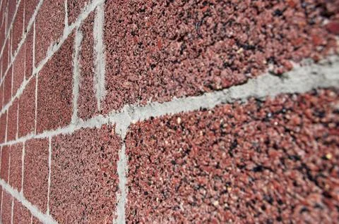 Angled view of cinder block made from crushed red brick Stock Photos