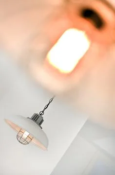 Angled view of a hanging light flashing with bllury Stock Photos