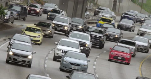 Angled view of heavy trucks in northbound traffic on 110 freeway in LA 4K Stock Footage 63643318