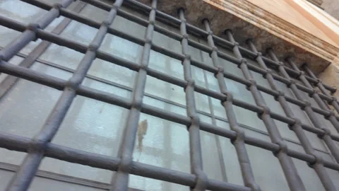 Angled view of iron bars on historic window in Vatican City showing texture.. Stock Footage 314375760
