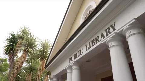 Angled view of public library columns and signage on building exterior, Woy Видео 332911029