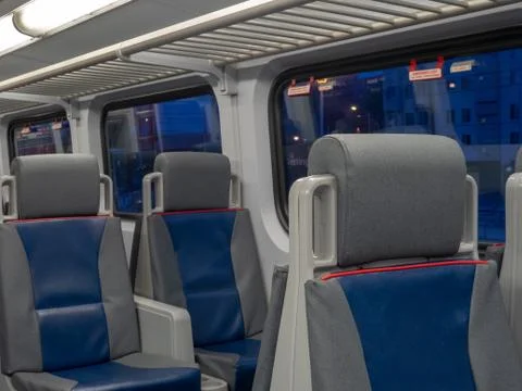 Angled view of seats on a train at dusk hours Stock Photos