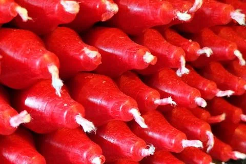 Angled view of a stack of red wax candles. Stock Photos