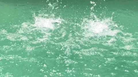 Angled View of Swimming Pool Waterfall with Splashing Clear Blue Water Video stock 337983176