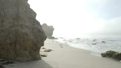 Angled view through special effects lens of Pacific Ocean, rocks and beach Stock Footage 219906754
