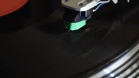 Angled view of turntable cartridge on spinning vinyl record Video stock 338172111