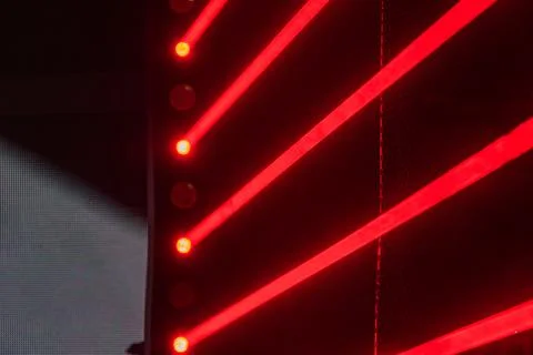 Angled view of a vibrant red and black lit stage, with a performer or technic Stock Photos