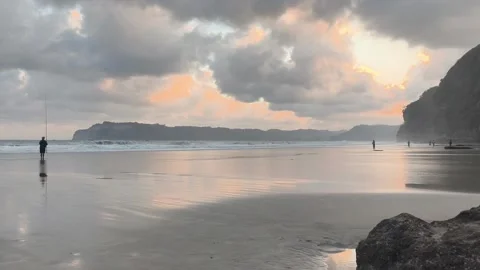 An angler on the beach at sunset. Stock Footage 340005115