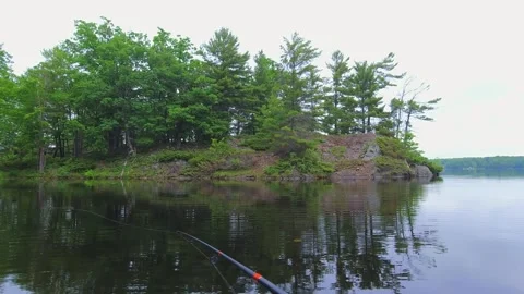 Angler casting rod with artificial baitfish lure for big mouth bass in the .. Stock Footage 282688772