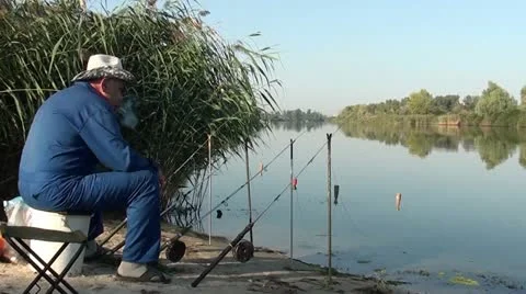 Angler smoking waiting for bite Stock Footage 12496853