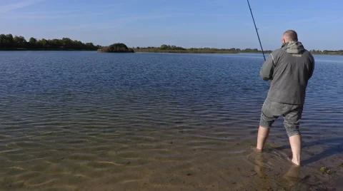 Angler tries to pull out fish Stock Footage