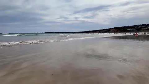 Anglesea Beach, Australia with crowds of people enjoy a summer day on the sand Stock Footage 297233337