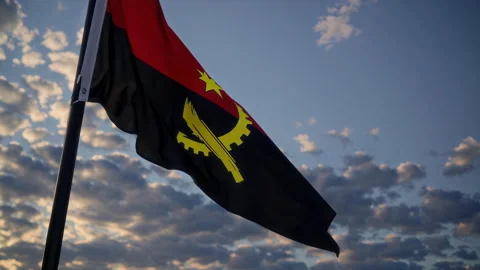 The Angolan Flag is Waving Gracefully in the Beautiful Sky During a Breathtaking Stock Footage 306174722
