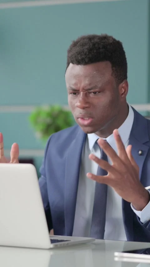 Angry African Man Fighting, Arguing while using Laptop, Vertical Video Stock Footage 339574313