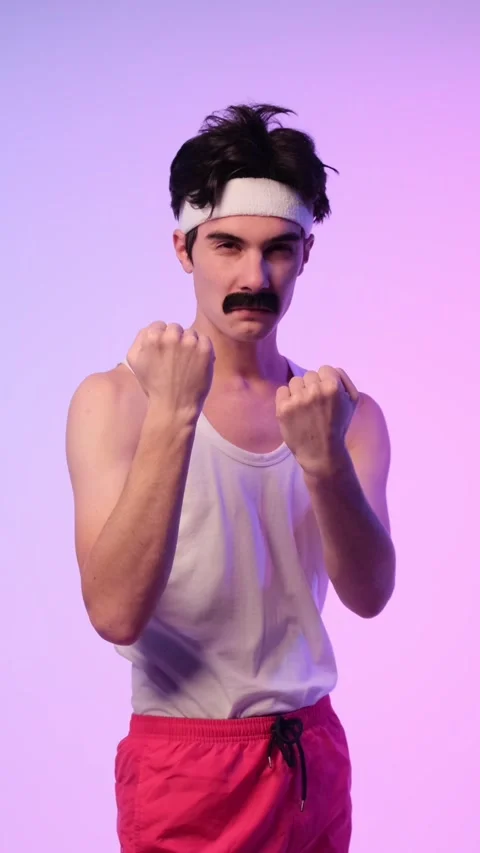 Angry And Aggressive Man Threatening With Fists On Purple Background Stock Footage 288828210