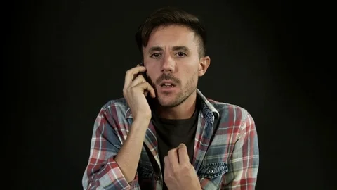 Angry and annoyed man screaming into mobile phone, arguing Stock Footage 80303605