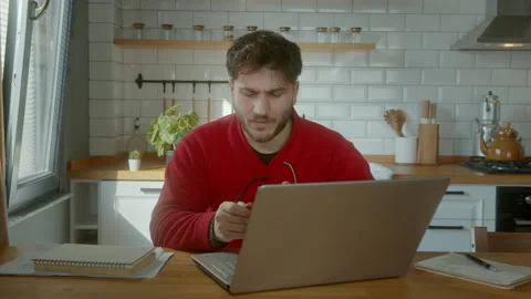 Angry and Frustrated Young Man Yelling at His Laptop in a Modern Kitchen, D.. Stock Footage 303669223