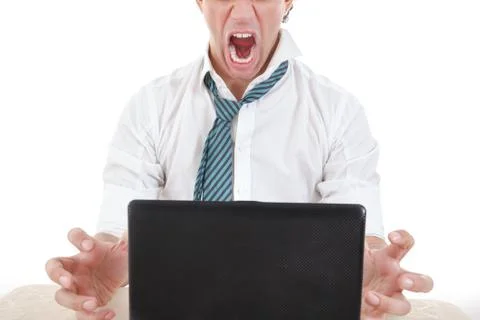 Angry and overworked half face business man with laptop in front of him on of Stock Photos