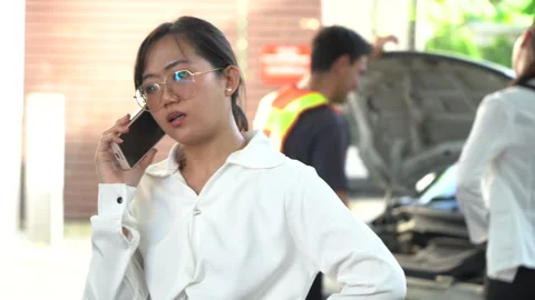 Angry asian woman driver using mobile phone during problem car call to Vehi.. Stock Footage 252956508