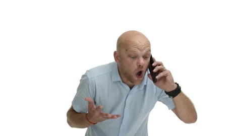 Angry bald guy with beard, wearing casual shirt, yelling at speakerphone Stock Footage 141685333