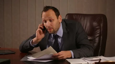 Angry boss talking on the phone in office Stock Footage 10956295