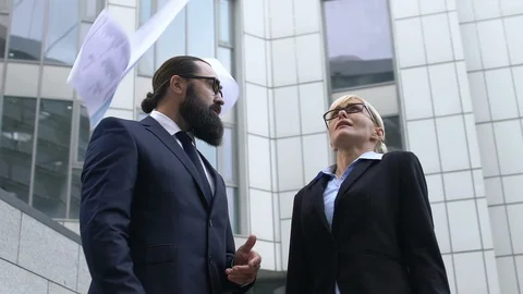 Angry boss throwing papers in front of confused secretary, dissatisfactory work Stock Footage 119036403