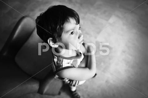 Angry boy in dark room, old style photography Stock Photos
