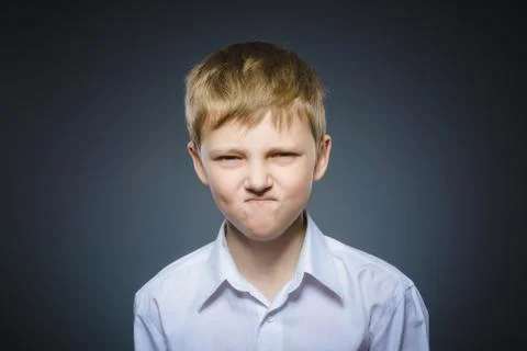 Angry boy isolated on gray background. Closeup Stock Photos