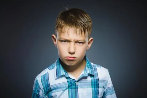 Angry boy isolated on gray background. Closeup Stock Photos