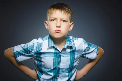 Angry boy isolated on gray background. Closeup Stock Photos
