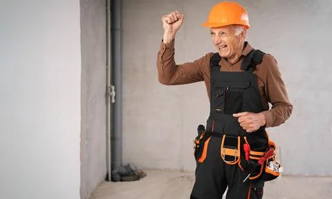 Angry builder worker shouting and waving fist. Construction site concept Stock Photos