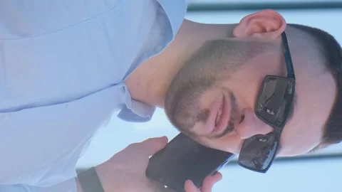 Angry businessman arguing while talking on smartphone, he is wearing a blue Stock Footage 250029003