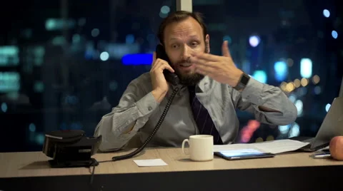 Angry businessman with documents and tablet talking on phone in office Stock Footage 56927952