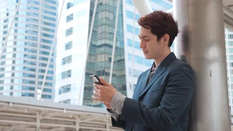 Angry businessman having problem with smartphone Stock Footage 155730454