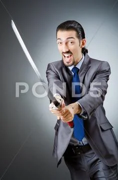 Angry businessman with sword in dark room Stock Photos