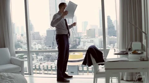 Angry businessman throwing documents standing by the window, 240fps Stock Footage 86236216