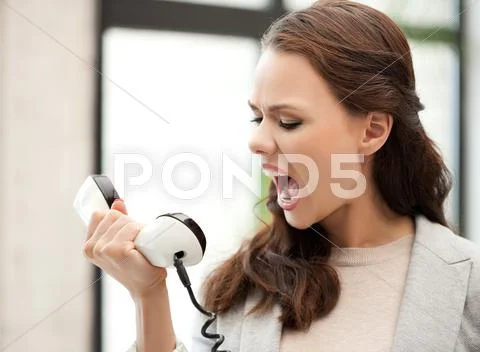 Angry businesswoman shouting at phone Stock Photos