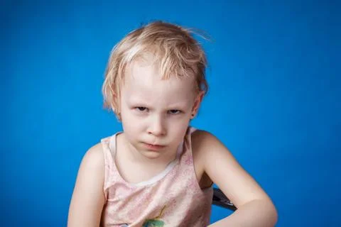 Angry child on a blue background Foto stock