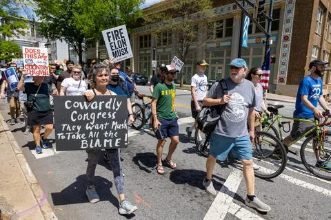 Angry citizens display signs marching in Hands Off protest event Stock Photos