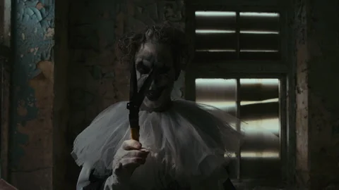 Angry Clown with Big Scissors Approaching Camera Stock Footage 250939624