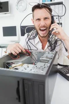 Angry computer engineer making a call Stock Photos